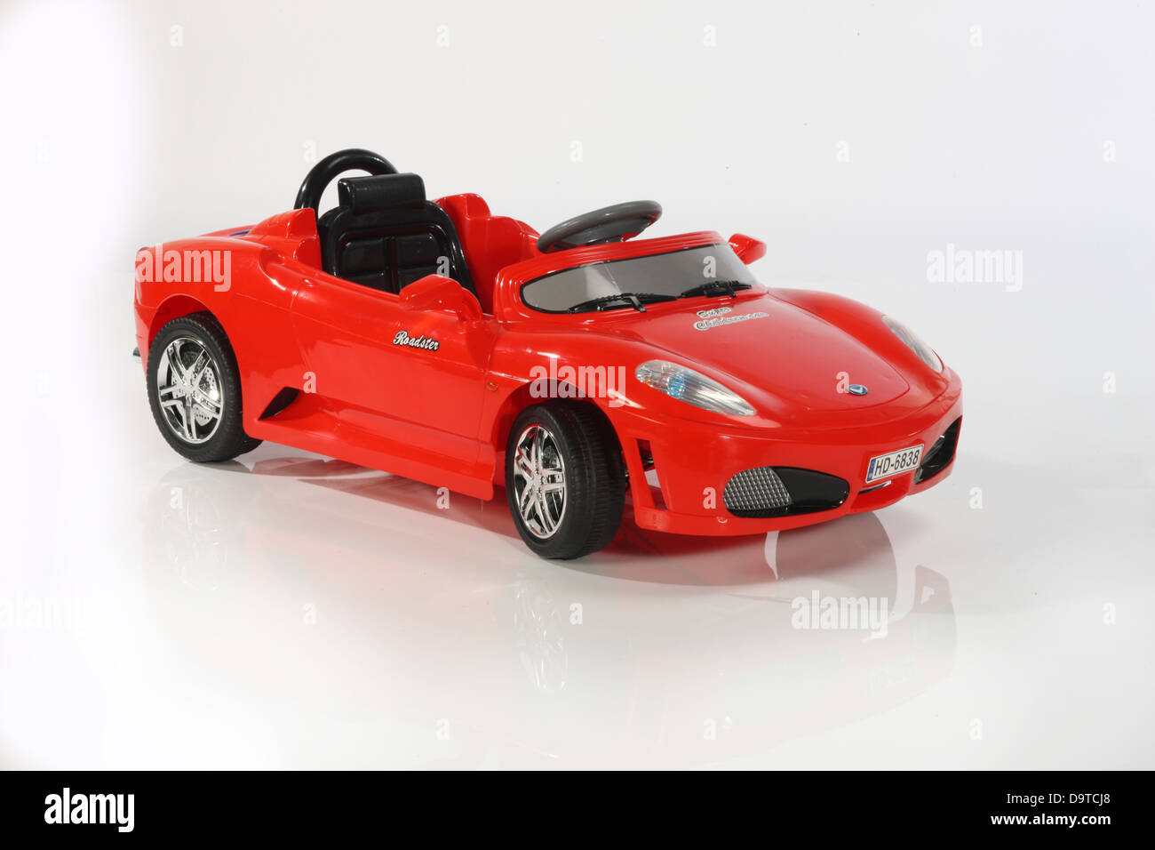 Kids pedal and electric cars on white backgrounds. Stock Photo