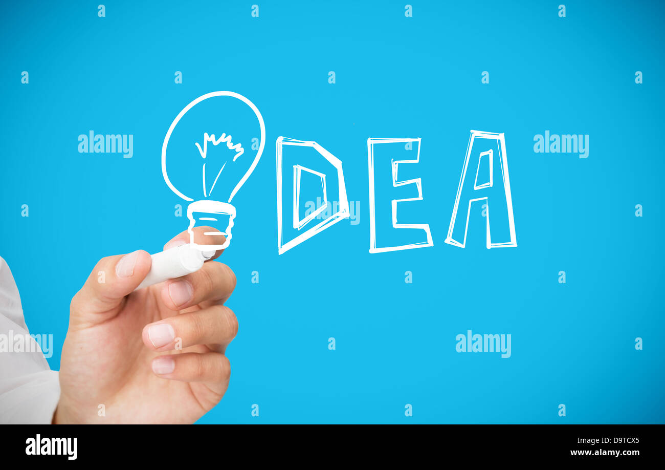 Businessman drawing light bulb as the i in idea Stock Photo
