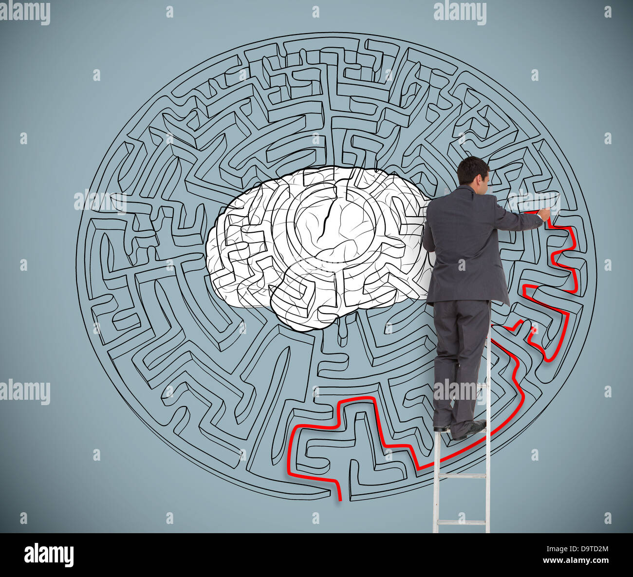 Businessman trying to solve a large maze with a brain illustration Stock Photo