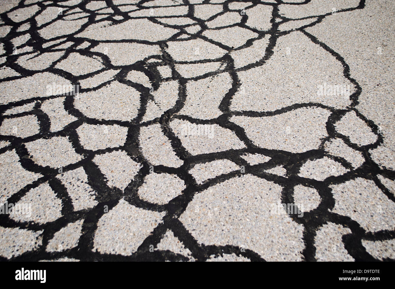 tar pattern on cracked asphalt Stock Photo