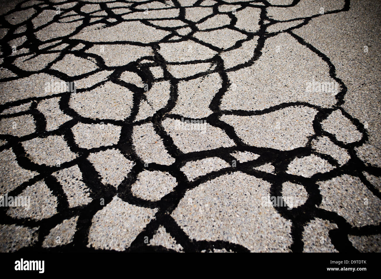 tar pattern on cracked asphalt Stock Photo