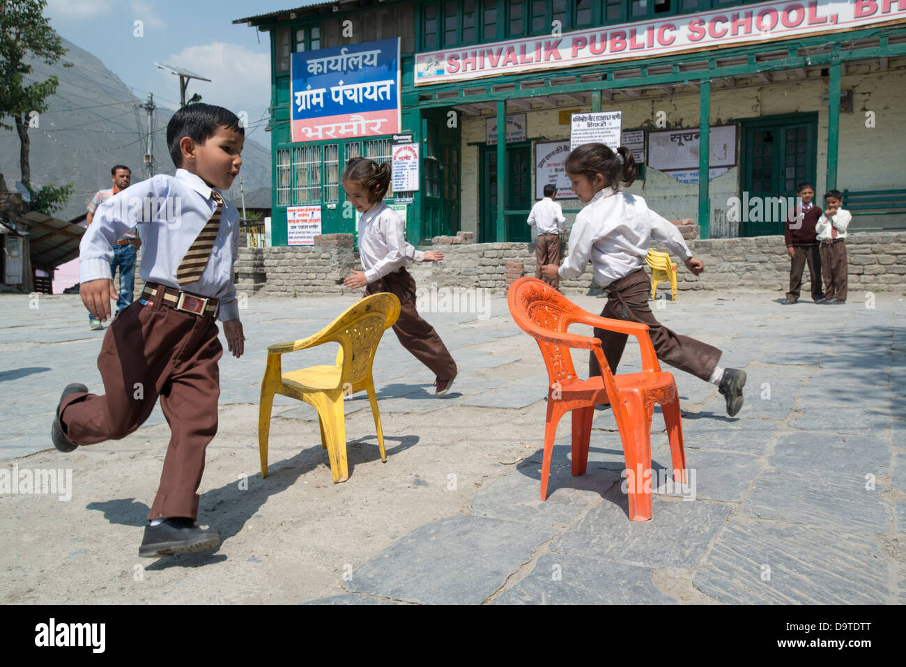 Indian primary schoolchildren play a game of Musical chairs in the