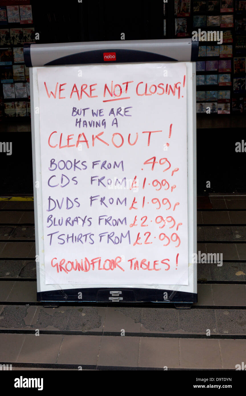A sign outside a HMV shop says 'We are not closing, but we are having a clear out'. Stock Photo
