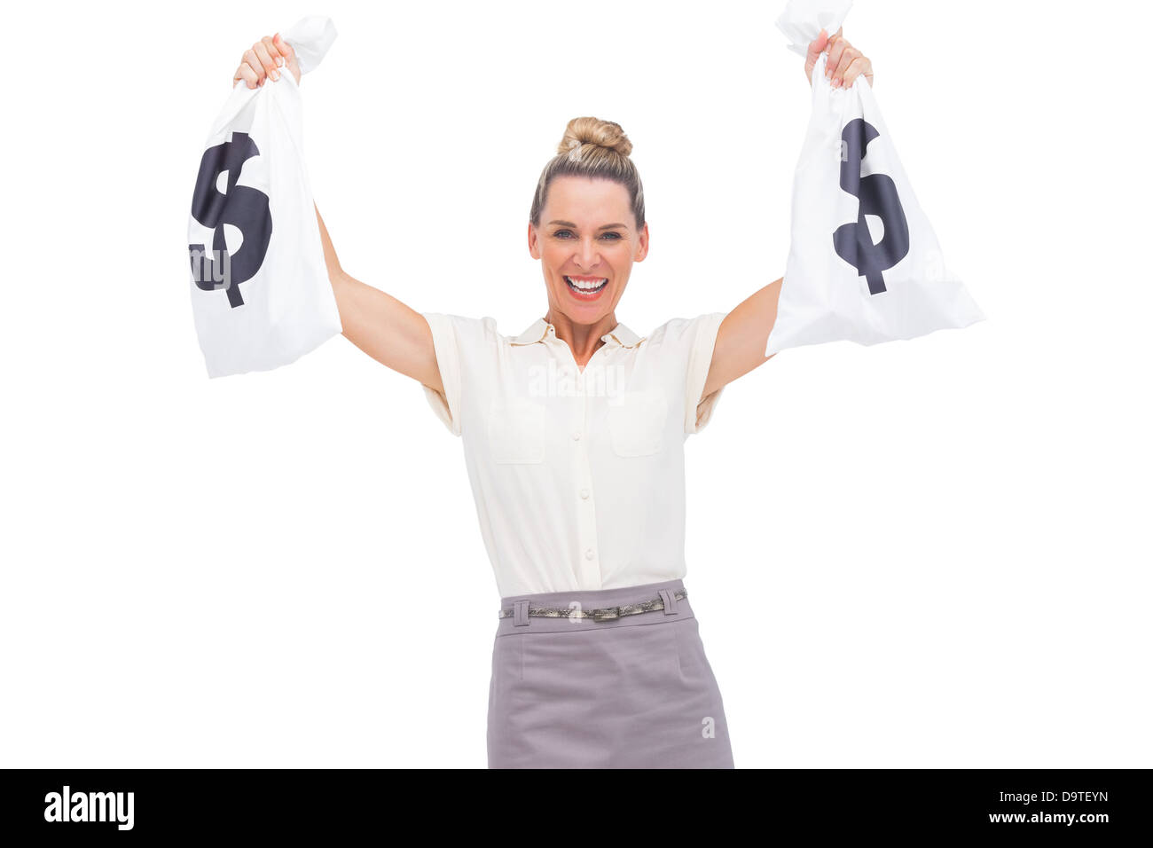 Smiling businesswoman showing money bags Stock Photo