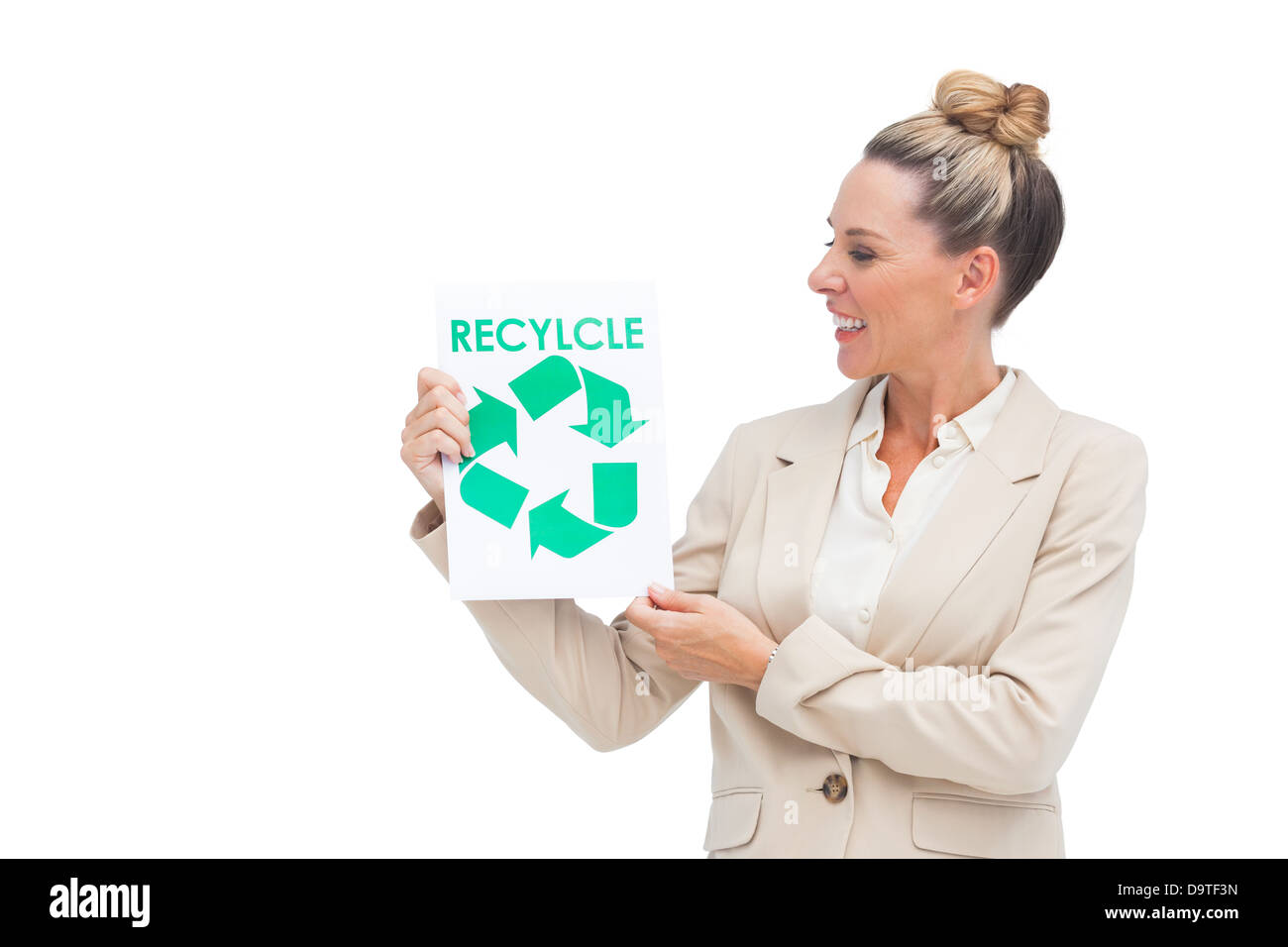 Businesswoman looking at recycling logo on paper Stock Photo