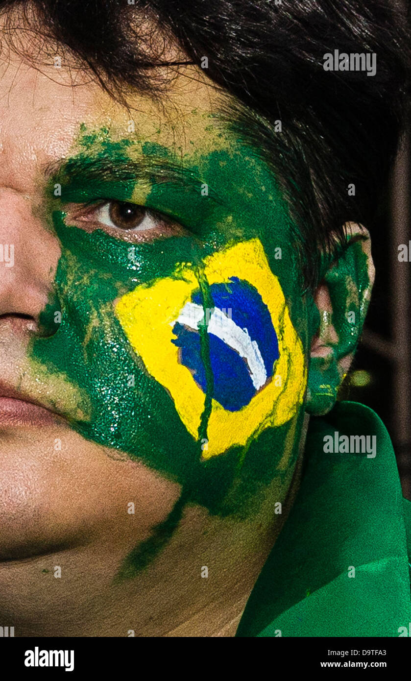 Brazil protest, Rio de Janeiro downtown, June 20, 2013. Brazil flag with tear painted on protester´s face creativity Stock Photo