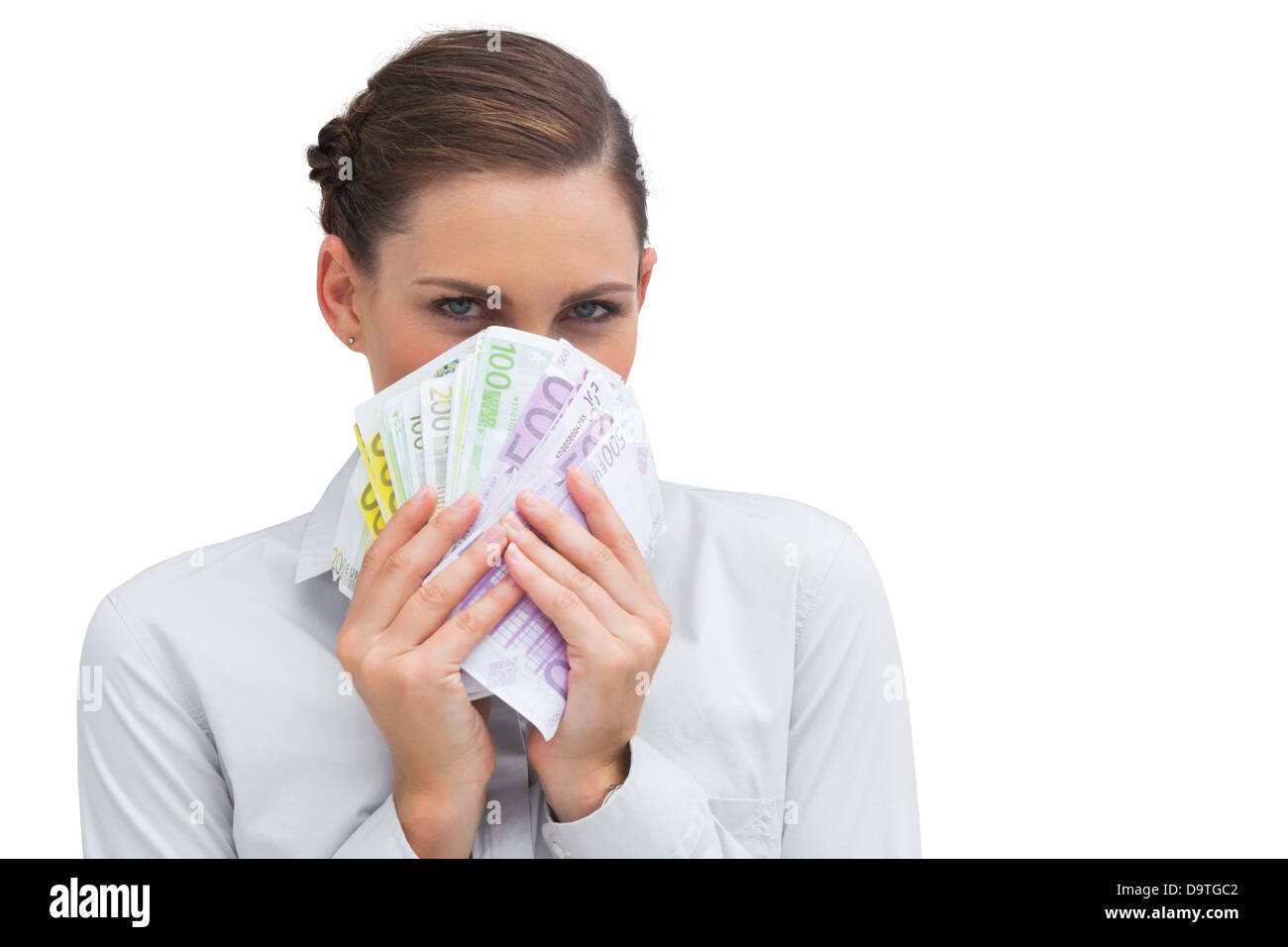 Businesswoman hiding behind money in her hands Stock Photo
