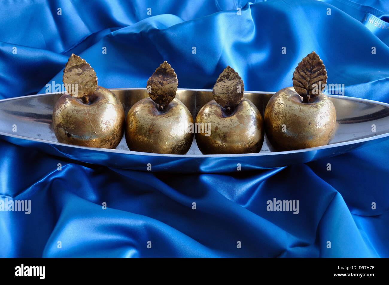 Golden apples on blue background. Christmas symbol vintage decorative objects. Stock Photo