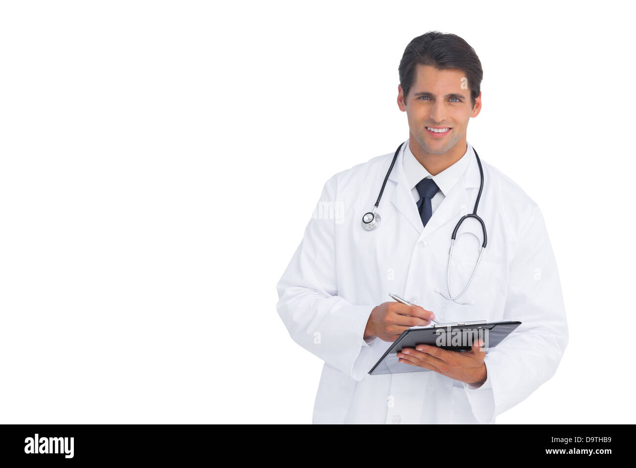 Smiling doctor holding a clipboard and pen Stock Photo - Alamy