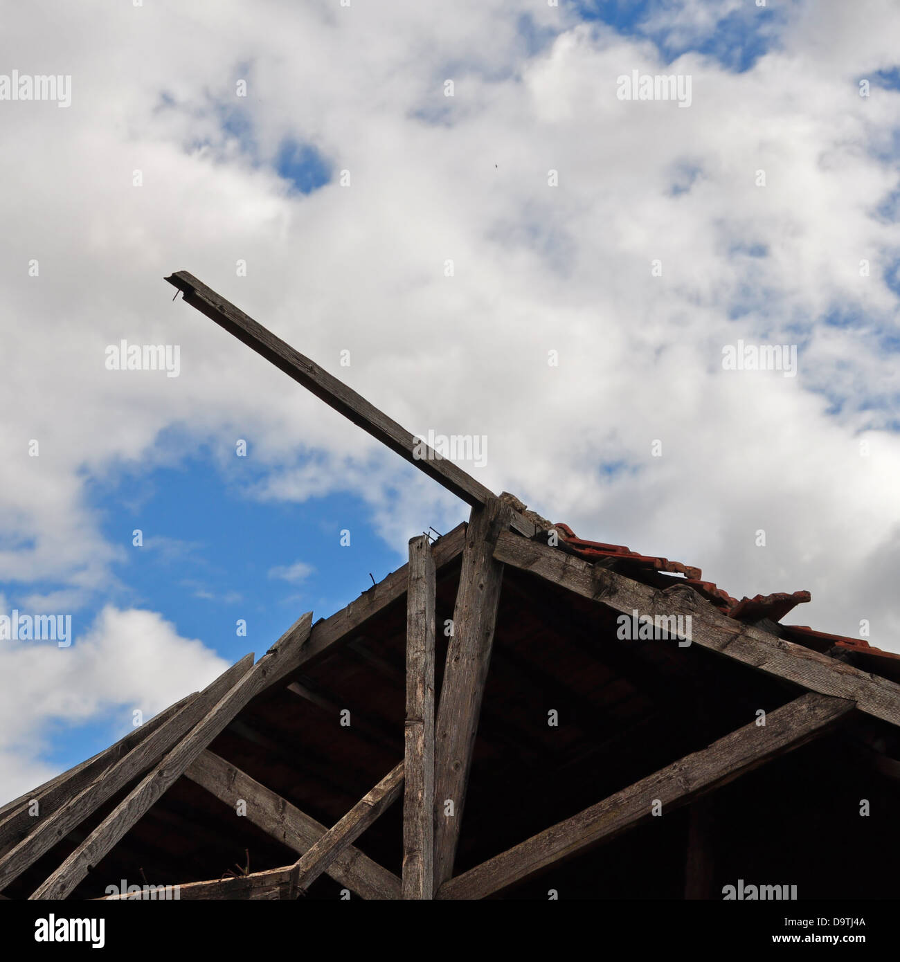 Collapsed wooden roof of an abandoned house and cloudy sky Stock Photo ...