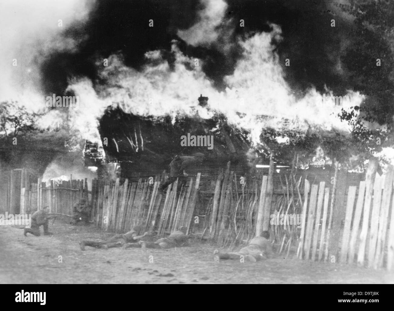 The Nazi Propaganda! on the back of the image reads: 'Military police fights with Bolshevist gangs. During the night, German police units in collaboration with tanks have encircled the bandit post tighter and tighter, which eventually burst into flames. Now, at dawn, an attack against the burning village is launched. Image from the Eastern Front/Russia, 14 October 1943. The attack on the Soviet Union by the German Reich was agreed on in July 1940 and prepared as the 'Operation Barbarossa' since December 1940. On 22 June 1941, the invasion by the German Wehrmacht started. Photo: Berliner Verlag Stock Photo