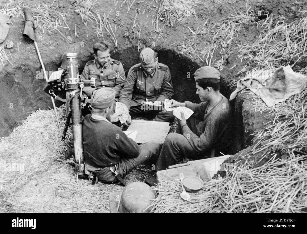 The Nazi Propaganda! on the back of the image reads: 'Four, who cannot be shattered by anything. There are still several hours until the next action. The best possible way to spent it is playing men skat.' Image is dated 13 July 1942. Fotoarchiv für Zeitgeschichte Stock Photo