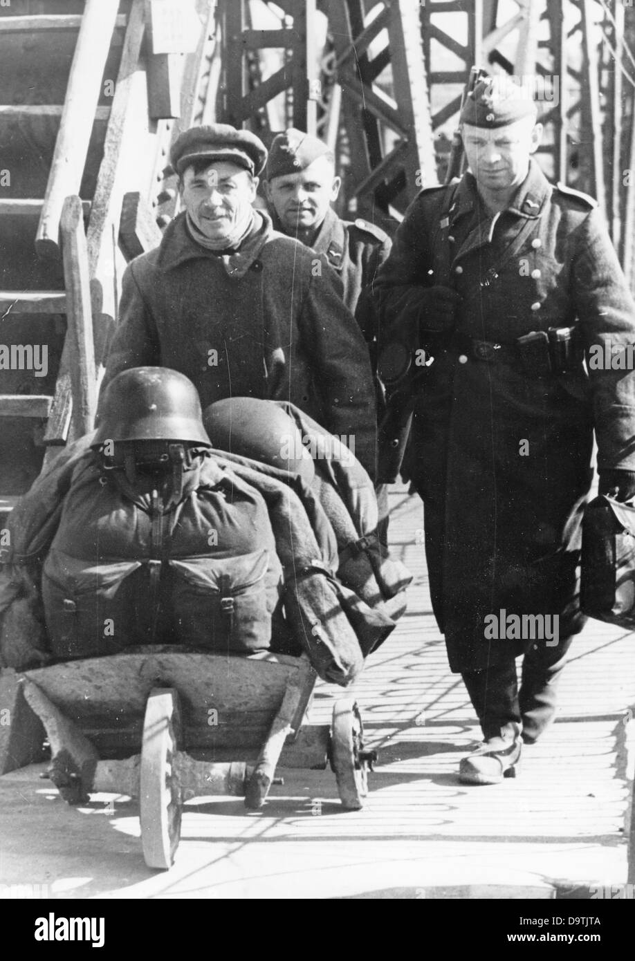 Soldiers of the German Wehrmacht prepare their home leave on the Eastern Front. Place unknown. The Nazi Propaganda! on the back of the image is dated 13 June 1942: 'These two Landser (Squaddies) earned their ticket home and the Russian drives their luggage with his special vehicle to the train station. In three days, they will be home.' Fotoarchiv für Zeitgeschichte Stock Photo