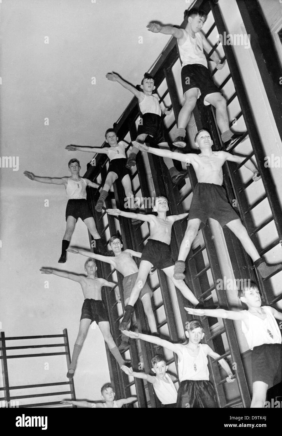 Hitler Youth boys of the German Youth present their skills on the ladders, in December 1937. Fotoarchiv für Zeitgeschichte Stock Photo