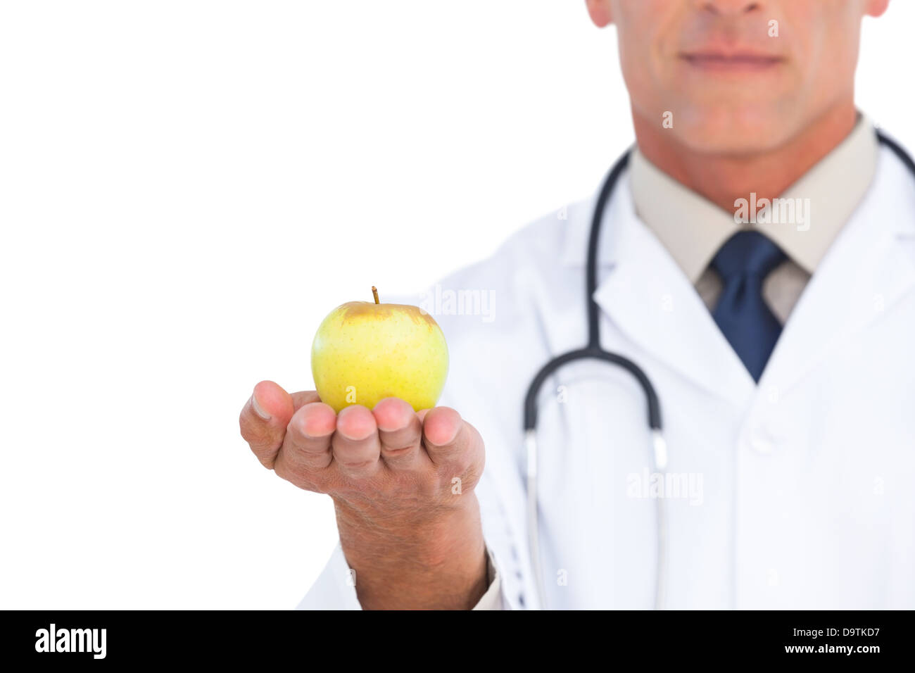 Focus shot on apple held by doctor Stock Photo