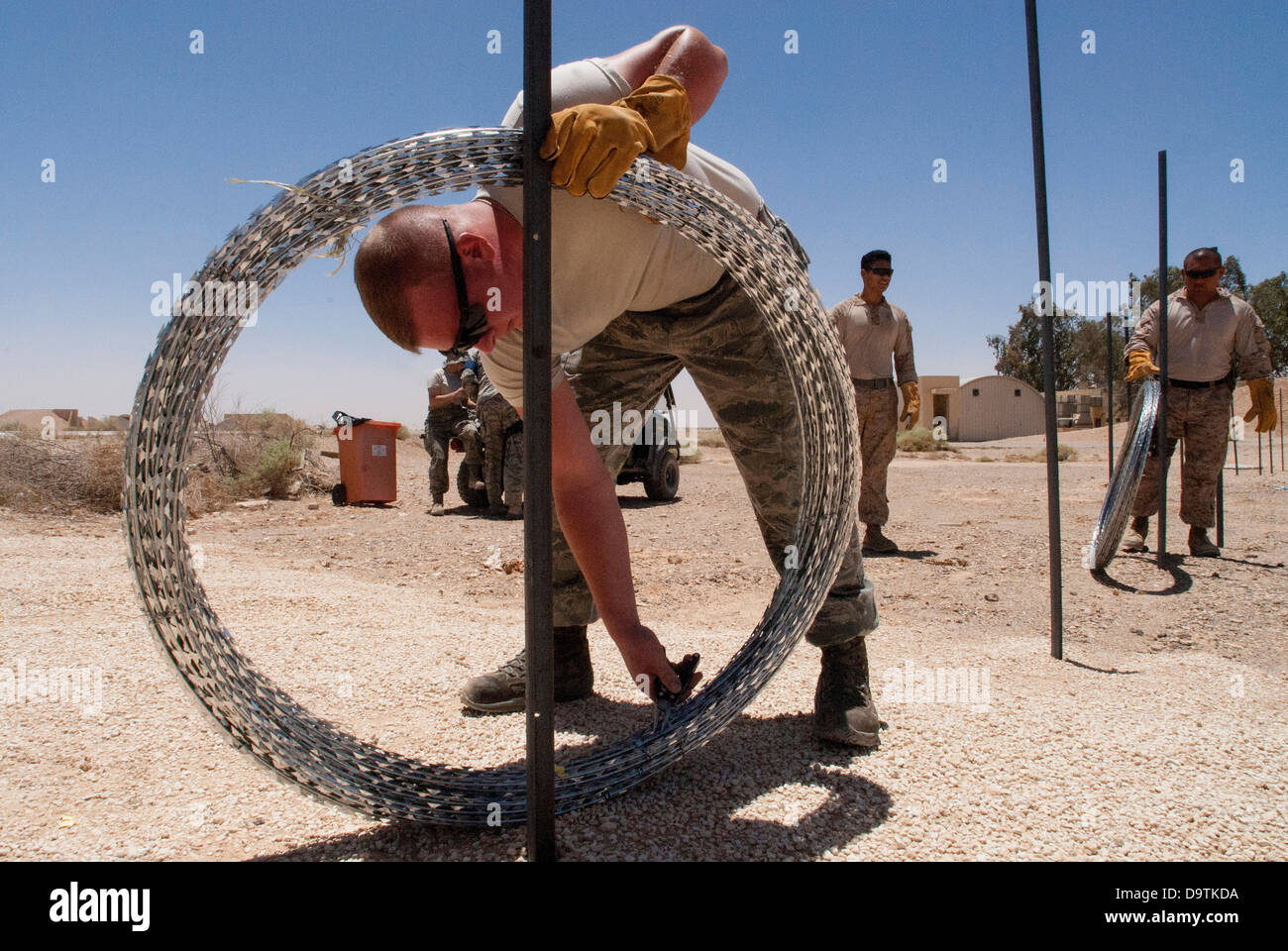 A security forces specialist from McGuire Air Base, New Jersey, installs Constantine wire for a defensive perimeter at a training base in Northern Jordan as part of the Eager Lion exercise. Eager Lion is a U.S. Central Command-directed, irregular warfare- Stock Photo