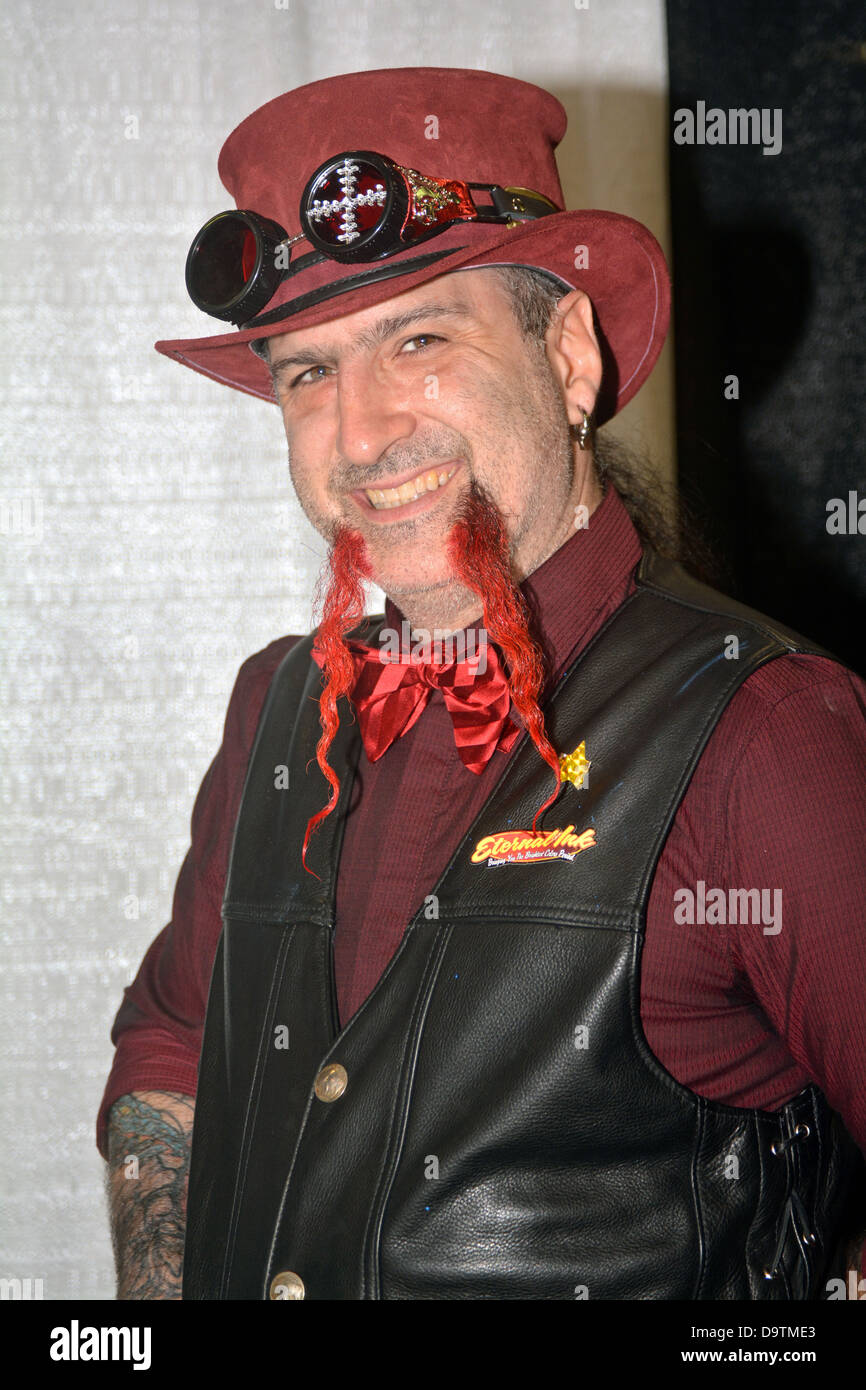 Portrait if Syx in a red derby with and odd red moustache at the New York Tattoo Festival in Uniondale, Long Island, New York Stock Photo