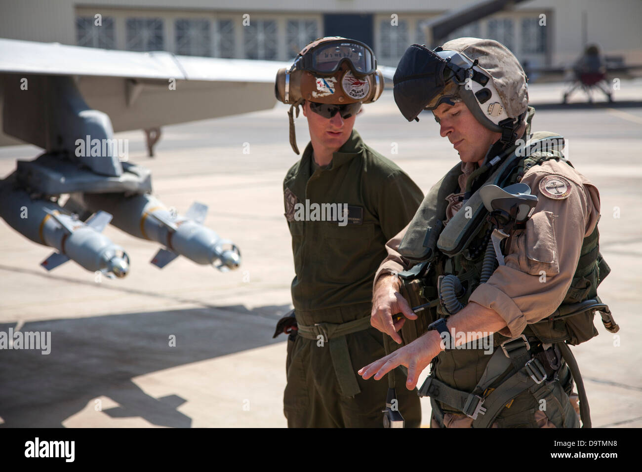 Marine Captain Matthew ”Toggaf” Holcomb (right) from the VMFA-115 squadron discusses aircraft maneuvers with his plane captain, Stock Photo