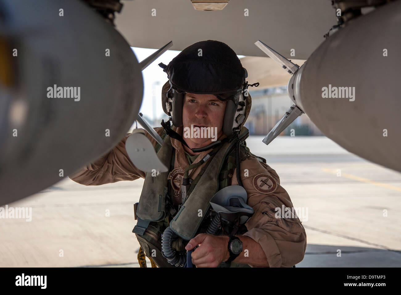 Marine Captain Matthew ”Toggaf” Holcomb from the VMFA-115 squadron performs pre-flight checks on his F-18 aircraft prior to takeoff. The Marine Fighter Attack squadron is operating out of a training base in Northern Jordan and is performing training and e Stock Photo