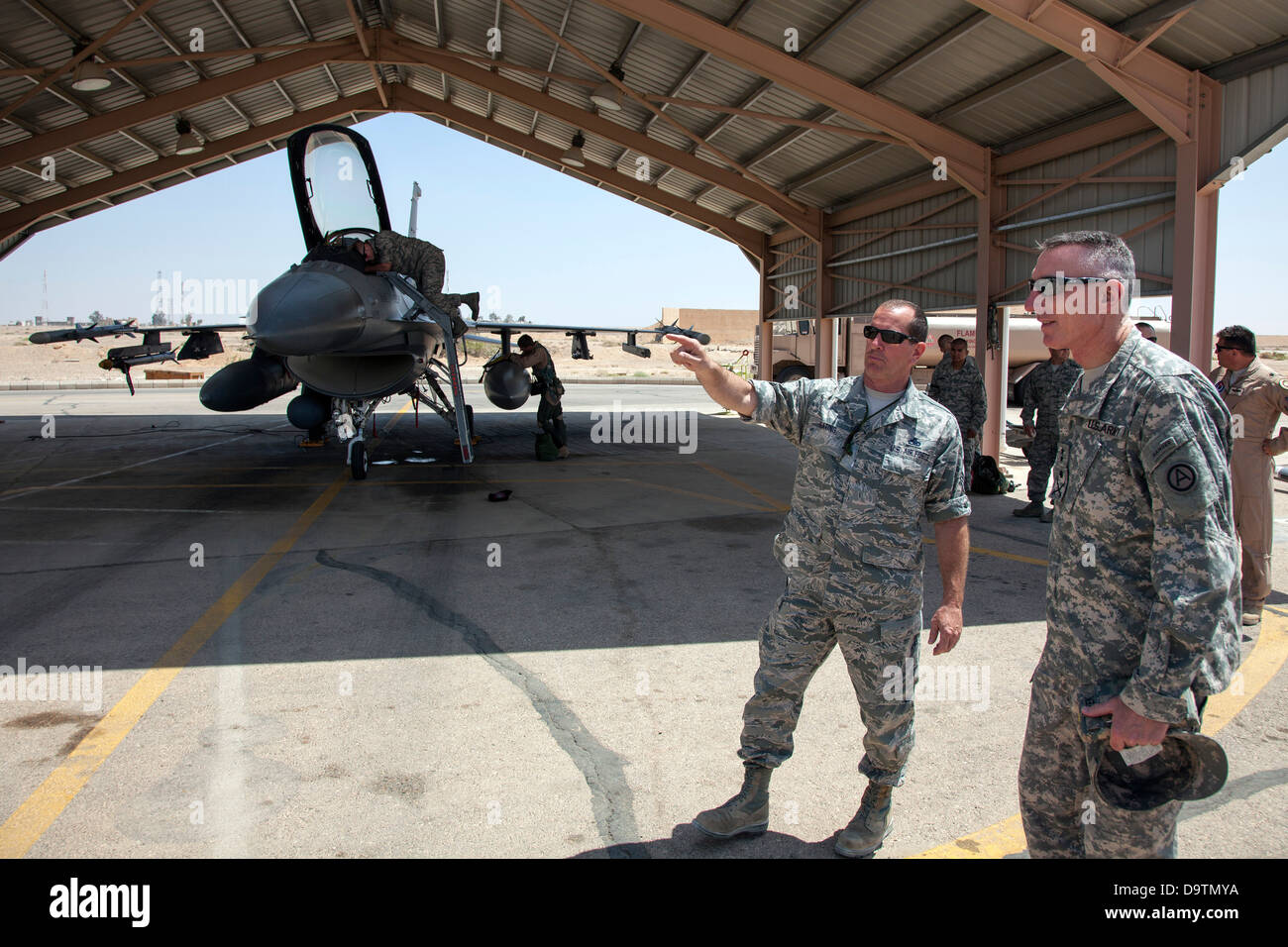 Chief Timothy Keating, from the 140th Wing, Colorado Air National Guard, explains maintenance operations to Major General Gary Cheek, deputy command general at Army Central Command during his visit to a training base in Northern Jordan as part of Exercise Stock Photo