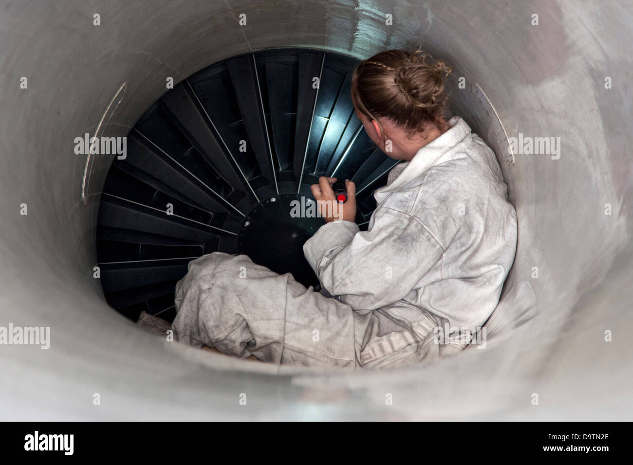 Senior Airman Kristen Lee, from the 140th Maintenance Squadron, Colorado Air National Guard, examines the intake of an F-16 Fighting Falcon after a flight in the skies over Jordan during the Eager Lion exercise. Eager Lion is a U.S. Central Command-direct Stock Photo