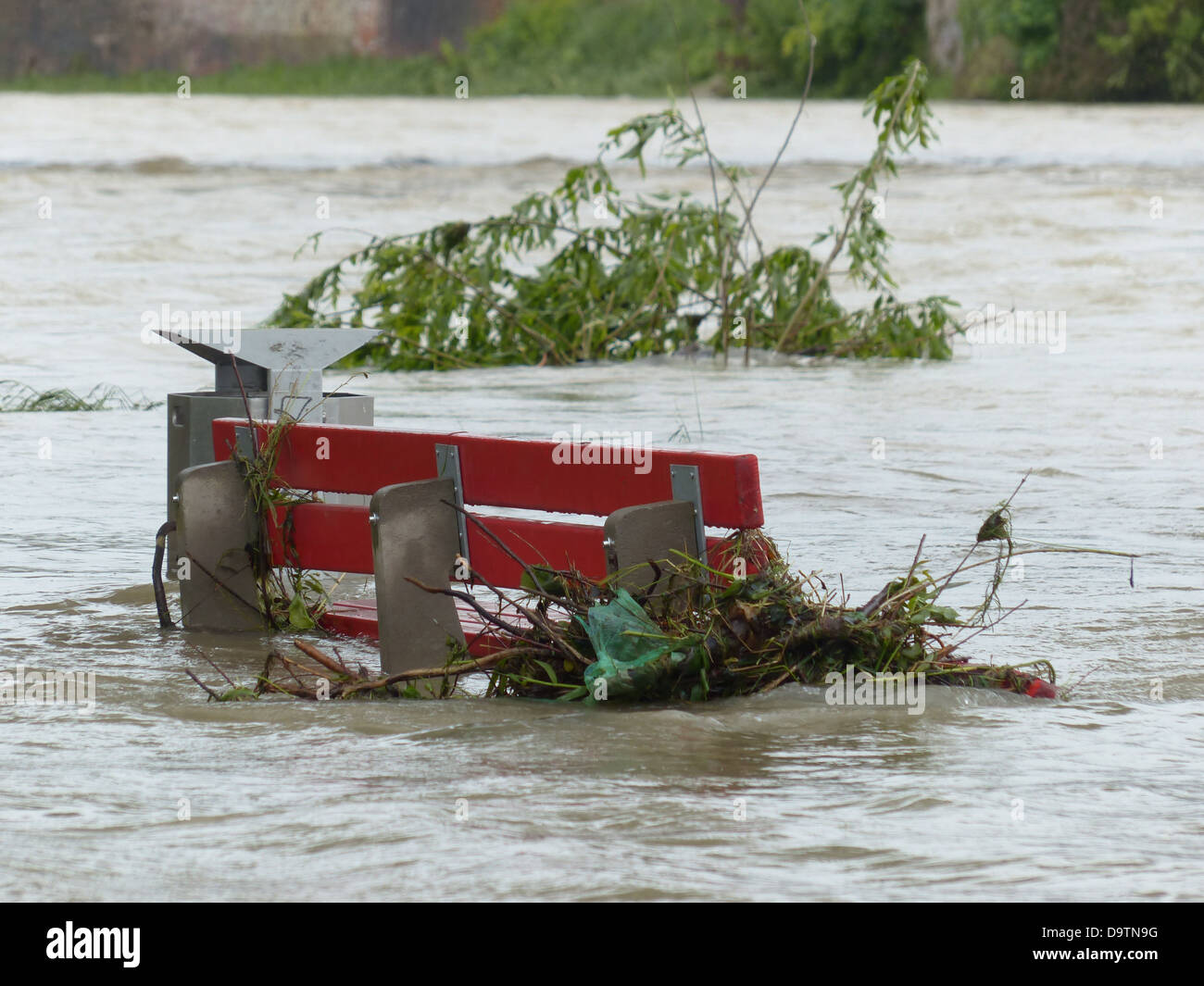 high water park bench flooded red natural disaster Stock Photo