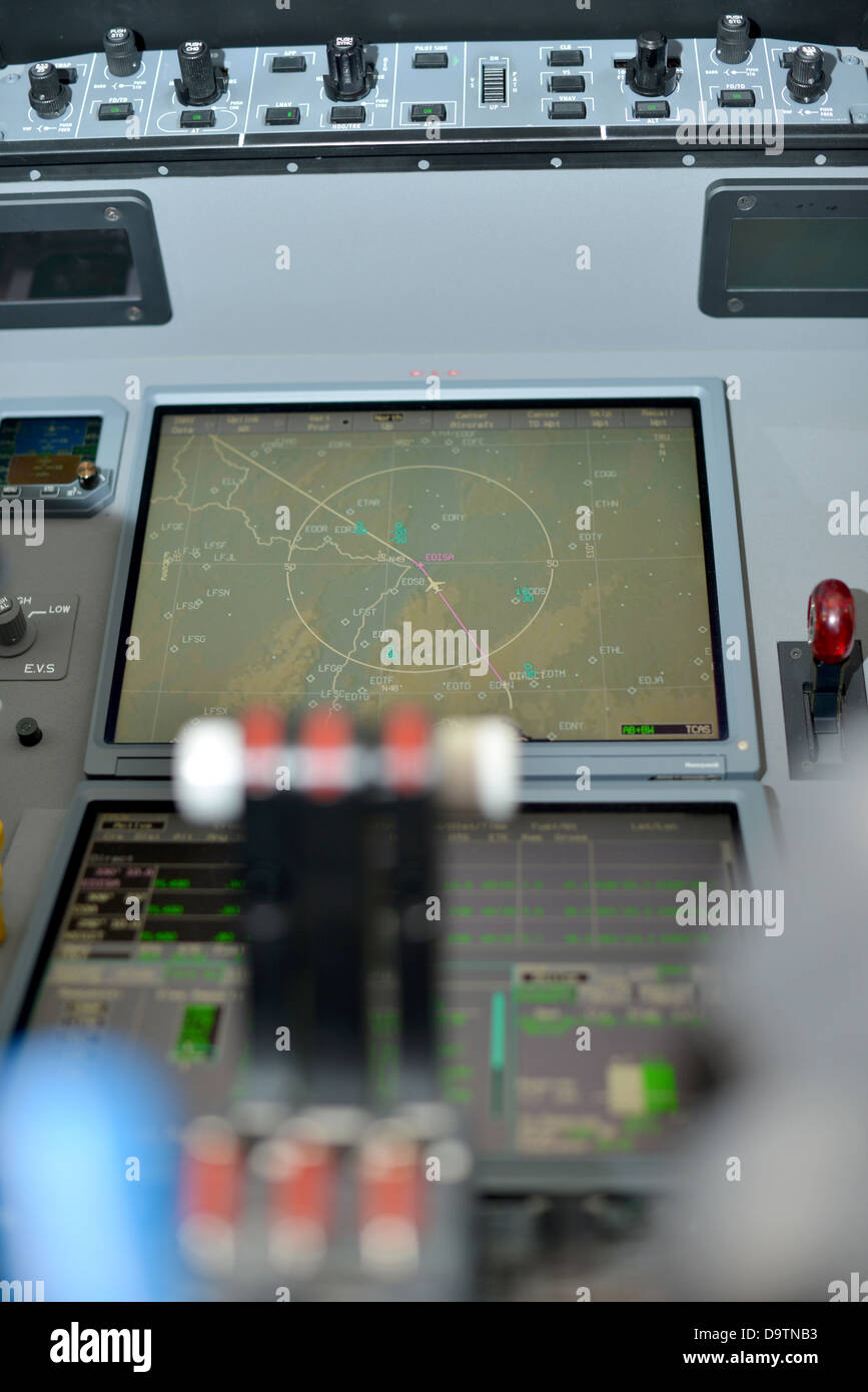 throttle levers and video displays in control panel in the cockpit of a jet plane Stock Photo