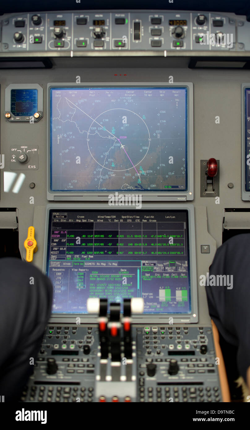 throttle levers and video displays in control panel in the cockpit of a jet plane Stock Photo