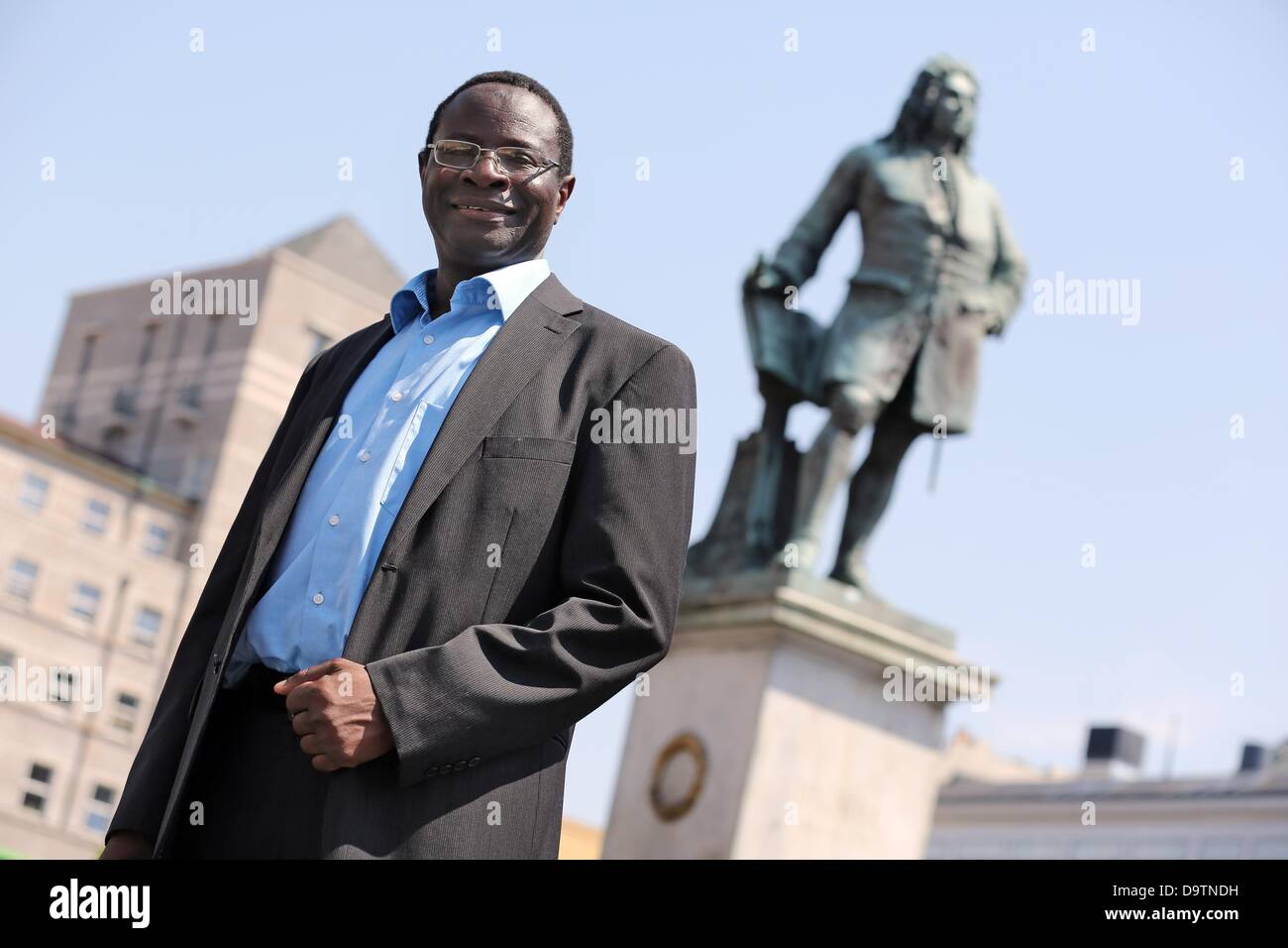Senegalese-born candidate of the SPD, Karamba Diaby, stands on the market square in Halle/Saale, Germany, 18 June 2013. Diaby is running as a SPD candidate in the forthcoming German federal election for the Bundestag, to be held on 22 September 2013, representing the 72nd constituency in Saxony-Anhalt. Diaby would be the first African-born politician to become member of the Bundestag, the SPD stated. Born in Senegal, Diaby has been a German citizen for 12 years. He joined the SPD in 2008 and has been a member on Halle's city council since 2009. Photo: Jan Woitas/dpa Stock Photo