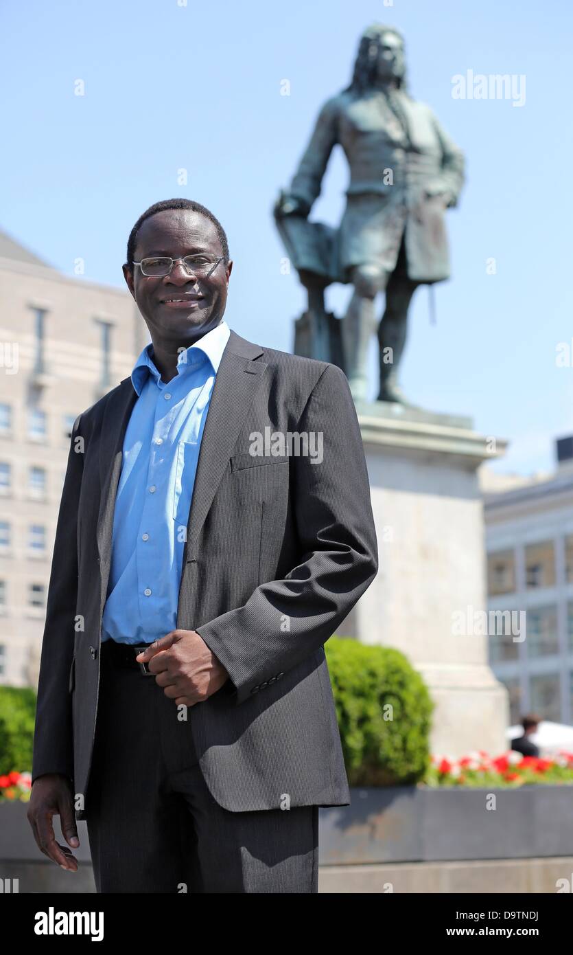 Senegalese-born candidate of the SPD, Karamba Diaby, stands on the market square in Halle/Saale, Germany, 18 June 2013. Diaby is running as a SPD candidate in the forthcoming German federal election for the Bundestag, to be held on 22 September 2013, representing the 72nd constituency in Saxony-Anhalt. Diaby would be the first African-born politician to become member of the Bundestag, the SPD stated. Born in Senegal, Diaby has been a German citizen for 12 years. He joined the SPD in 2008 and has been a member on Halle's city council since 2009. Photo: Jan Woitas/dpa Stock Photo