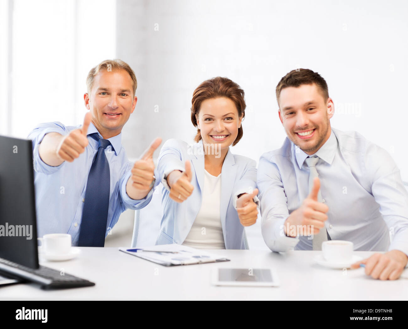 business team showing thumbs up in office Stock Photo - Alamy