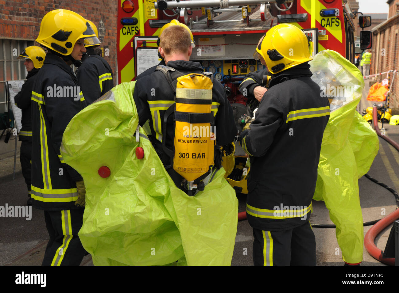 Firefighters check their breathing apparatus at the scene of an accident. Stock Photo
