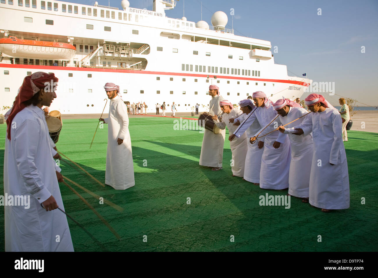 Arabic dance greeting to celebrate the arrival of the cruise ship MS Deutschland, at the port of Dubai, U.A.E. Stock Photo