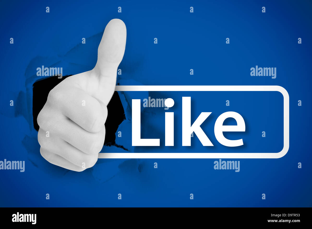 White thumb up tearing a canvas with the like from social networks Stock Photo