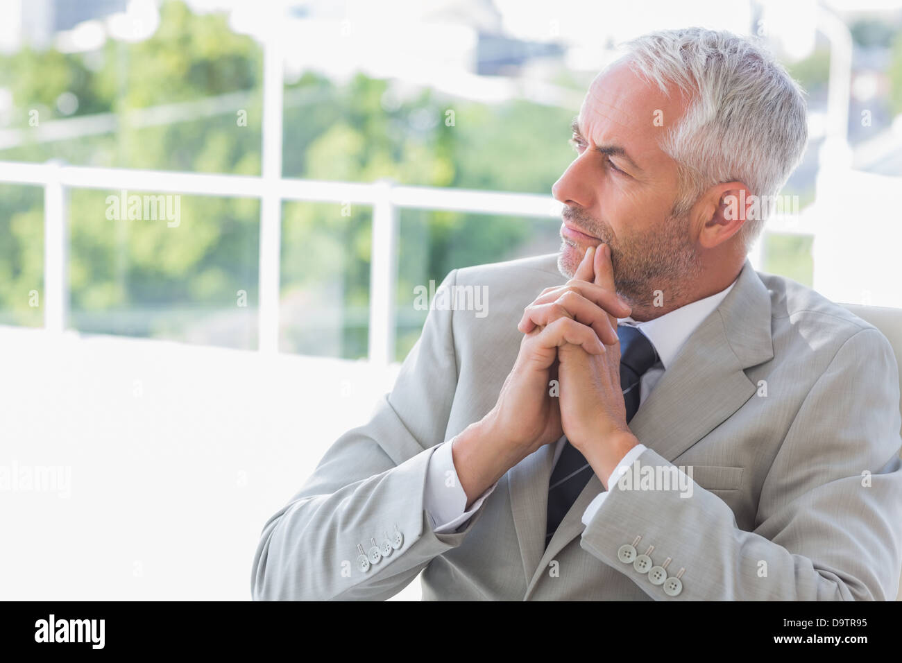 Thinking mature businessman sitting hi-res stock photography and images ...