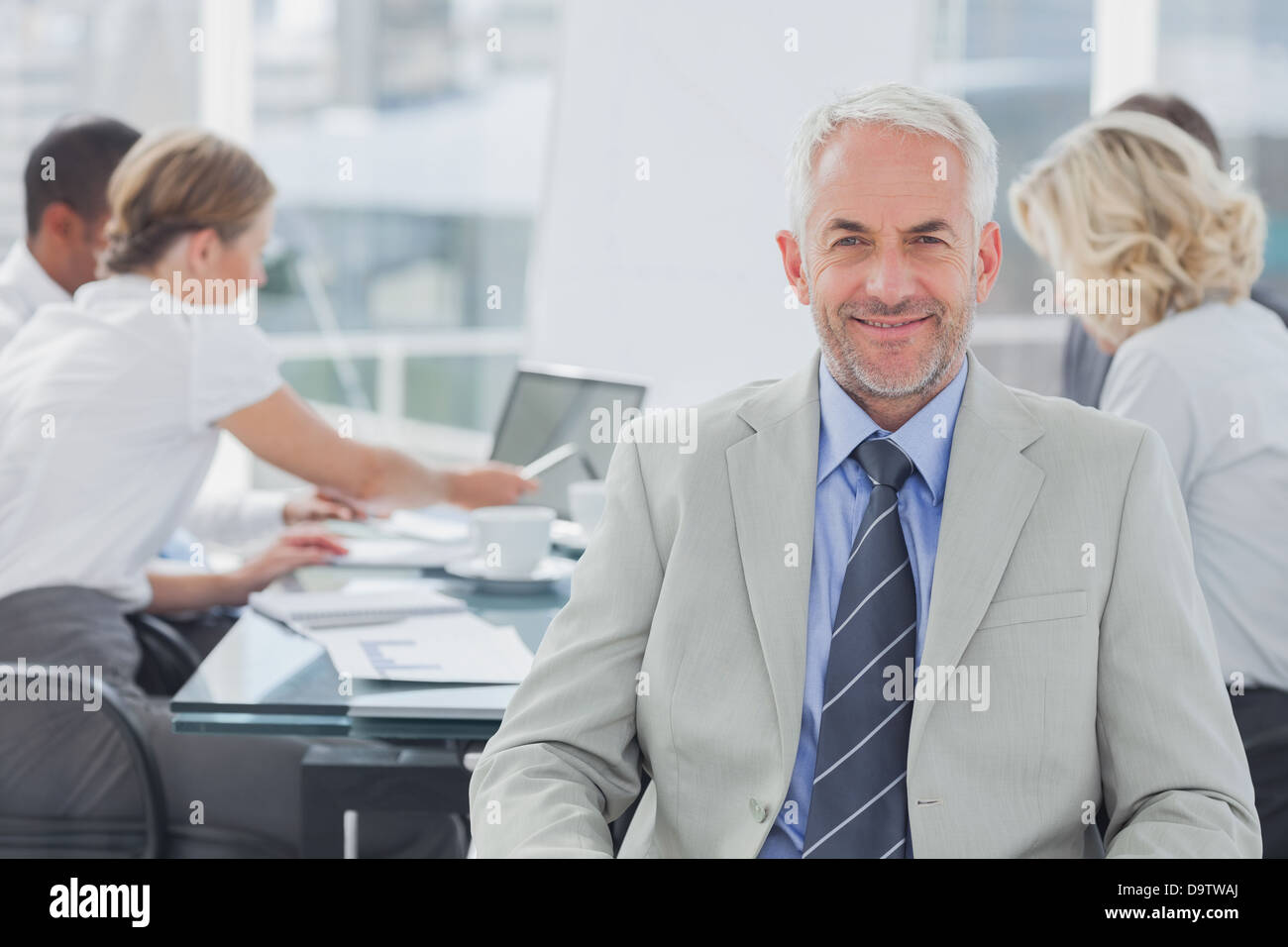 Charismatic businessman posing in the boardroom Stock Photo