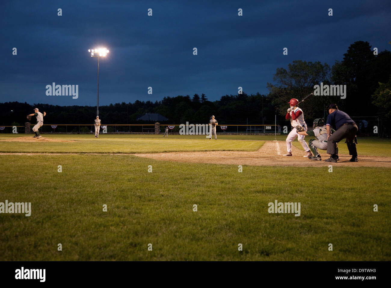 High school baseball features Nashoba Chieftans playing a nightgame in Western MA outside of Boston Stock Photo