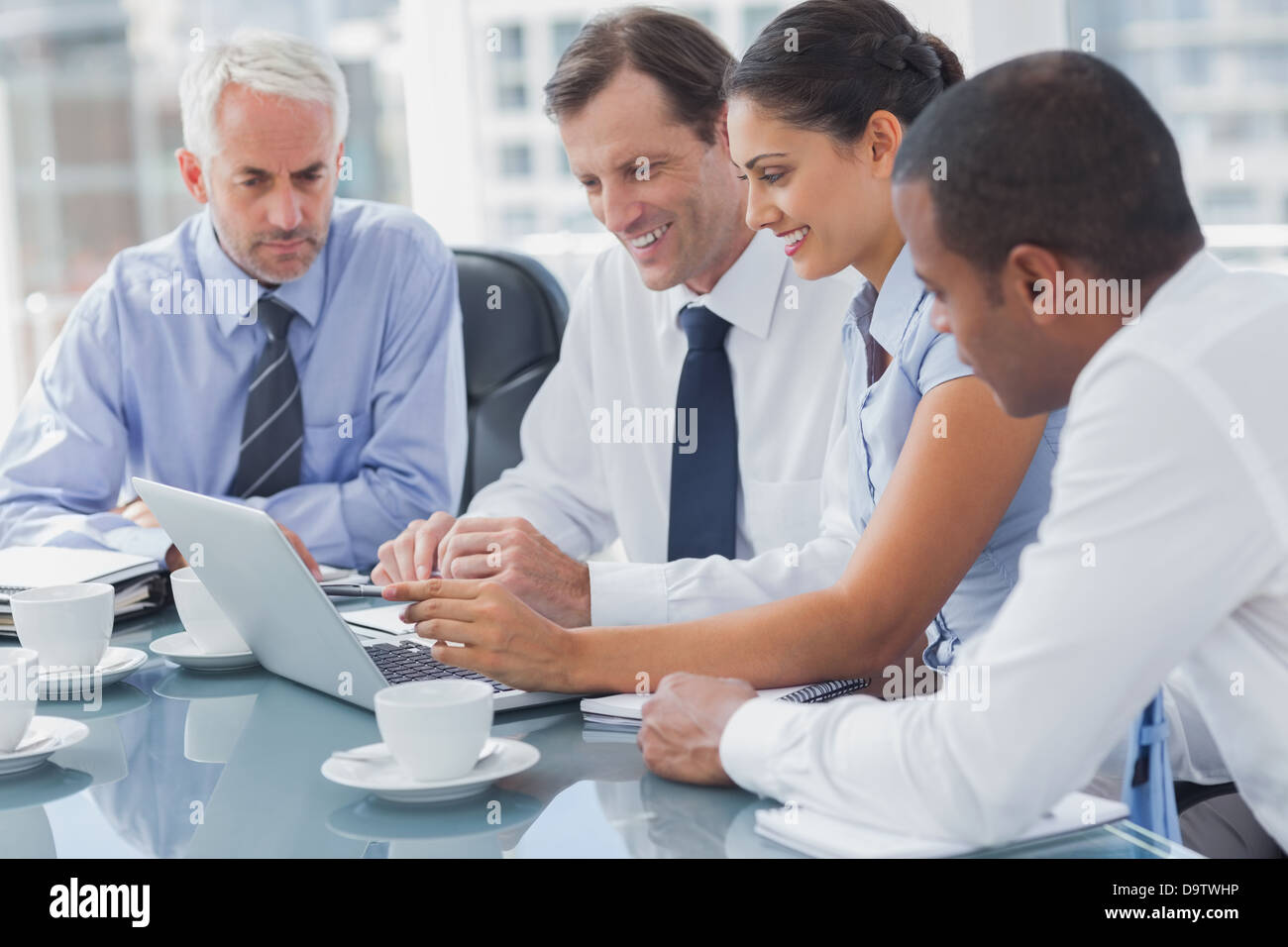 Business people looking at a laptop Stock Photo