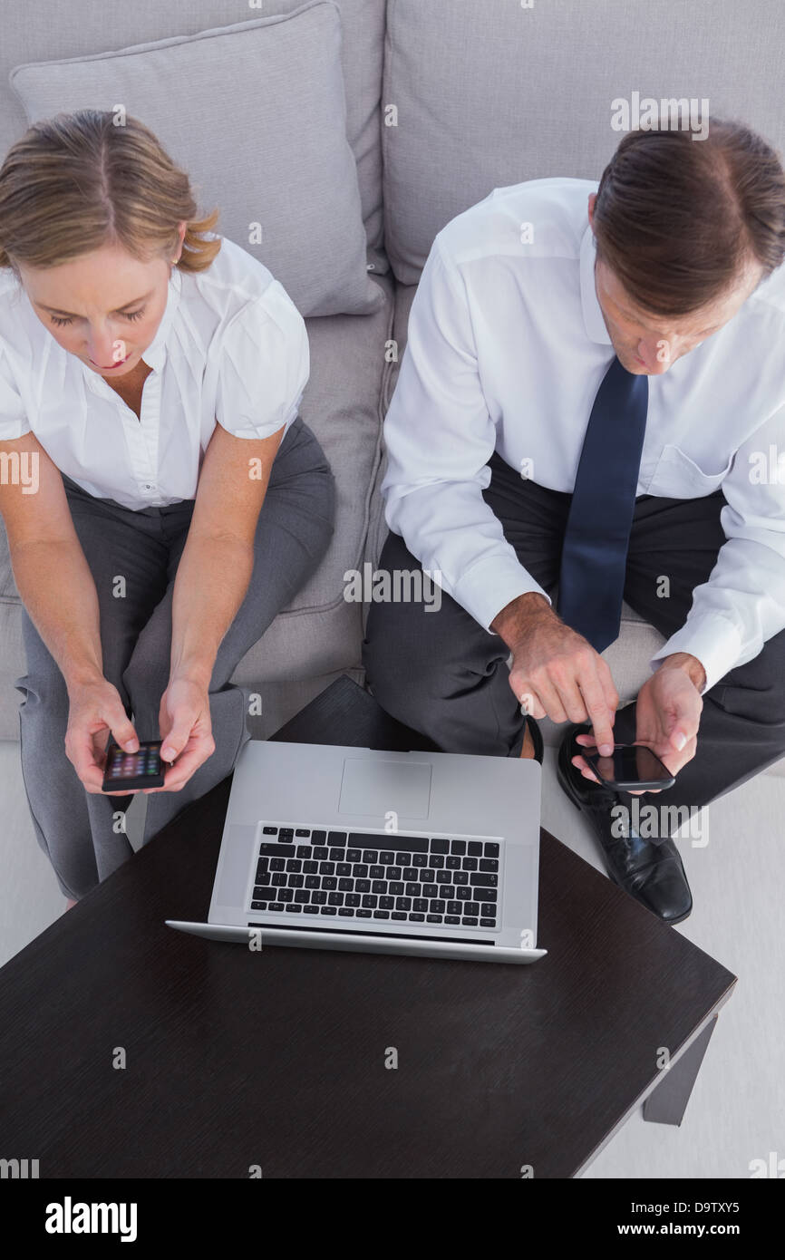 Overhead of business people using their mobile phones Stock Photo