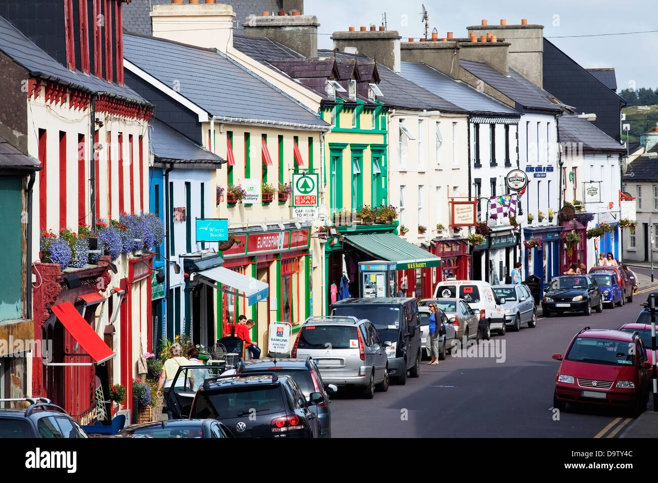 Busy street and colourful buildings in an irish village;Schull county