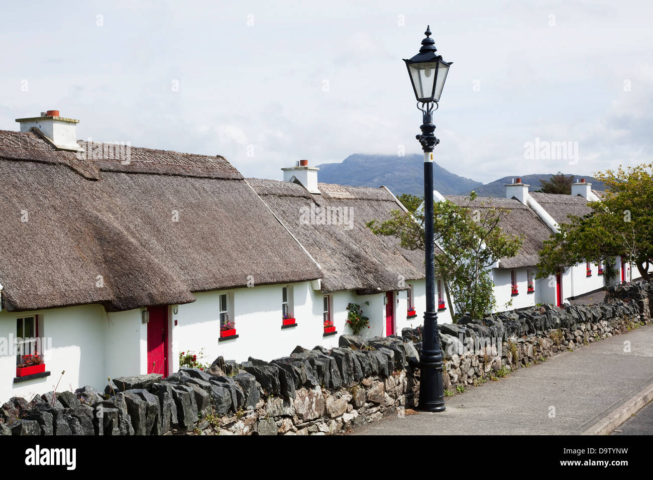 White cottages with red doors and red flower boxes in the windows