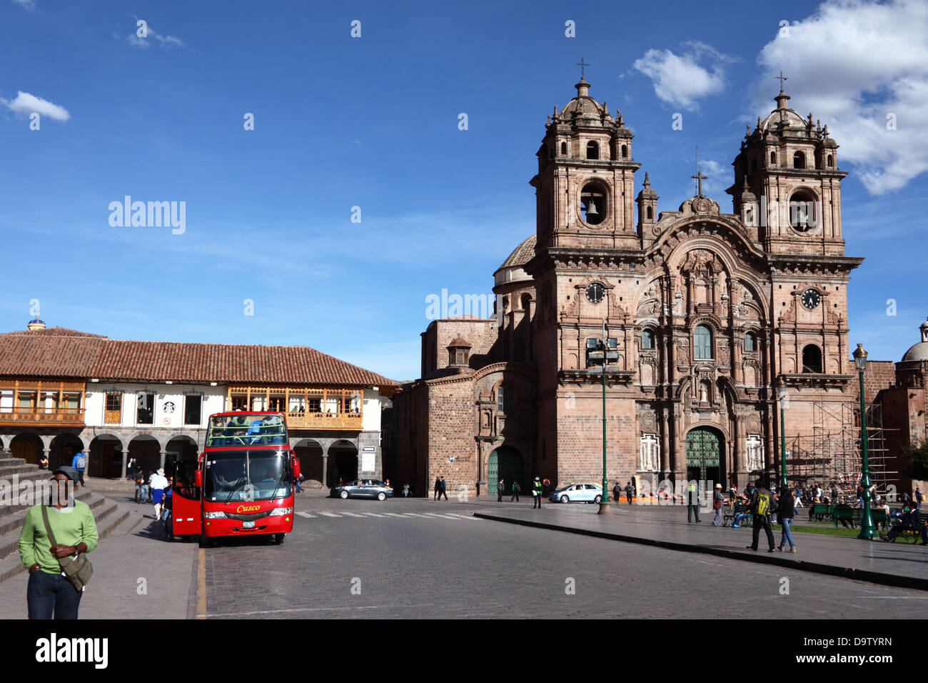 Open topped double decker sightseeing tour bus and Compañia de Jesus church , Plaza de Armas , Cusco , Peru Stock Photo