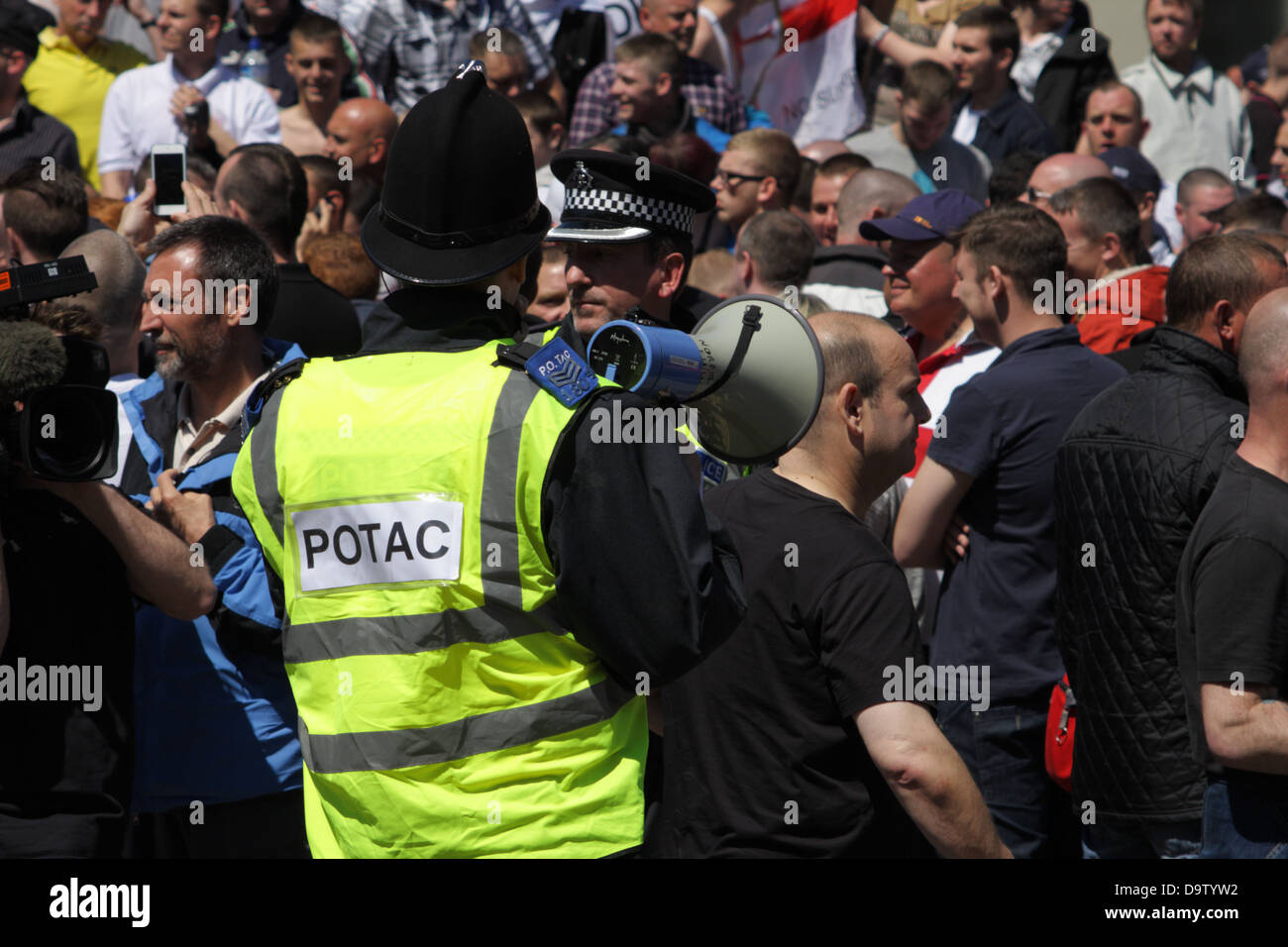 Public Order Tactical Advisor (POTAC) police officer with megaphone at a EDL demonstration in Newcastle upon Tyne, 2013 Stock Photo