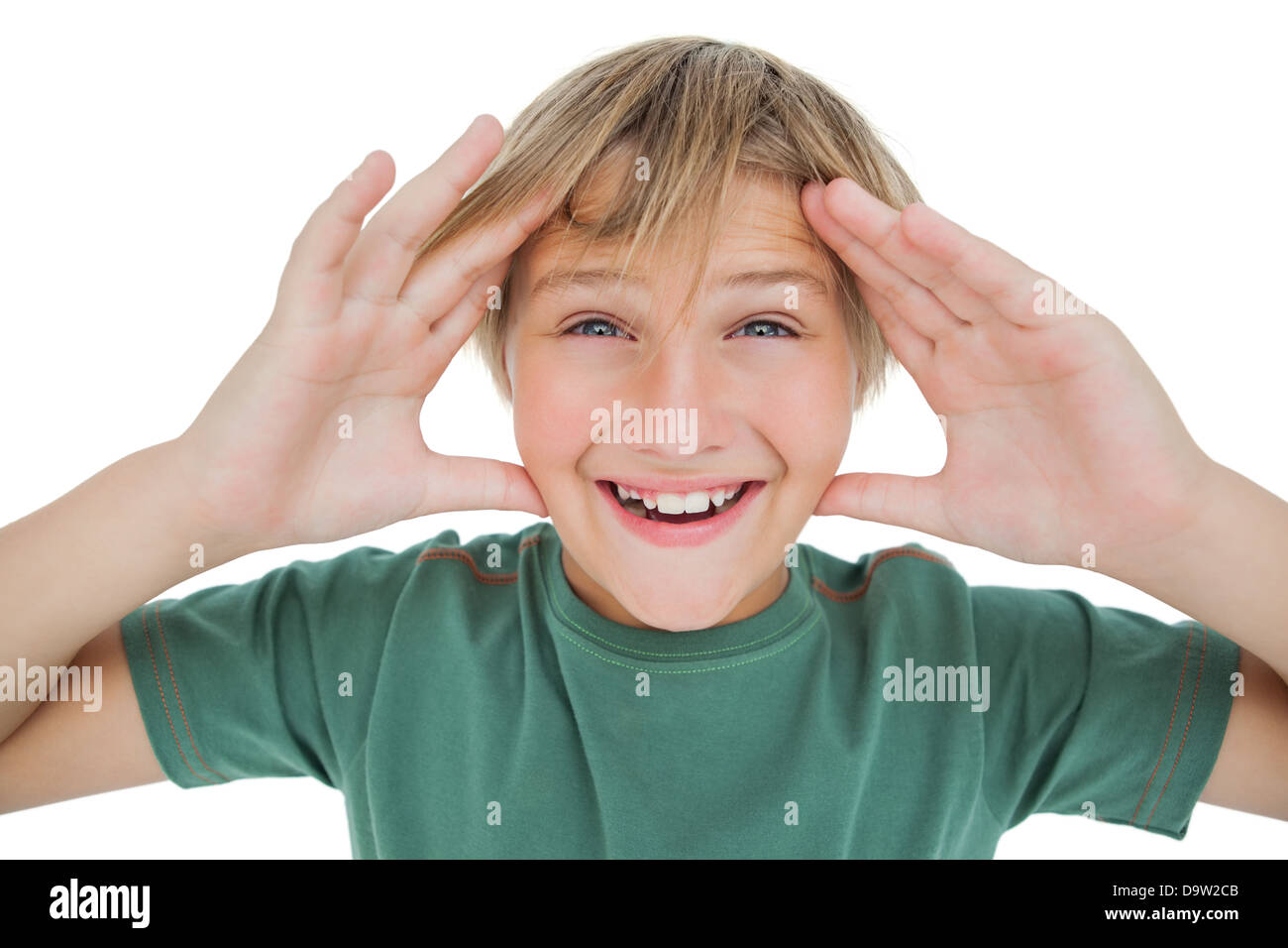 Surpised boy smiling with hands raised Stock Photo
