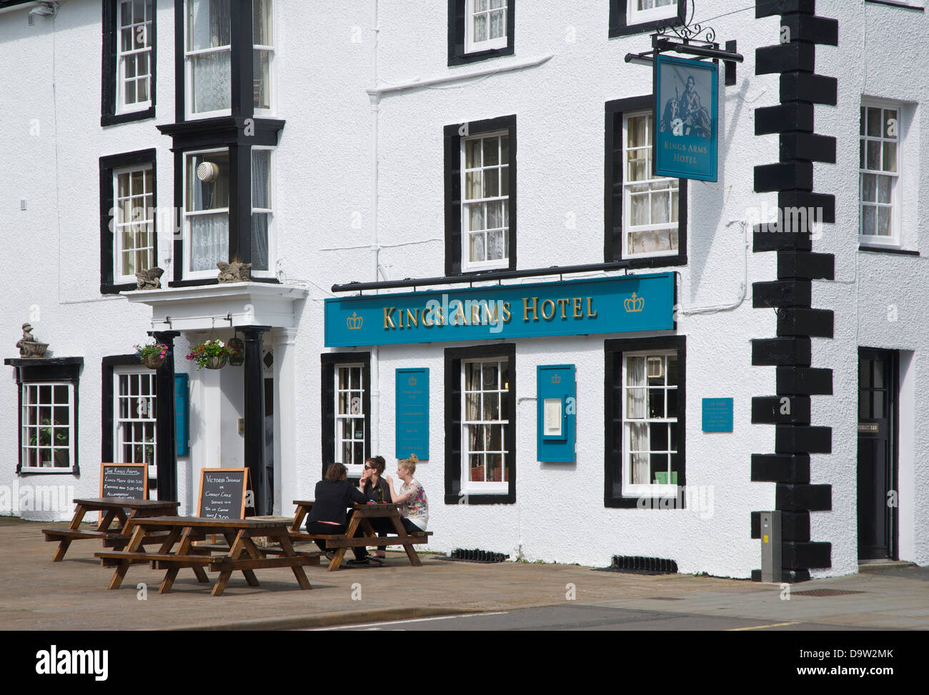 Three young women sitting outside the Kings Arms Hotel, in Kirkby