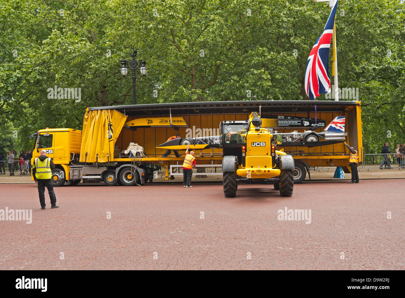 Loading the JCB dieselmax by forklift onto a lorry. Stock Photo