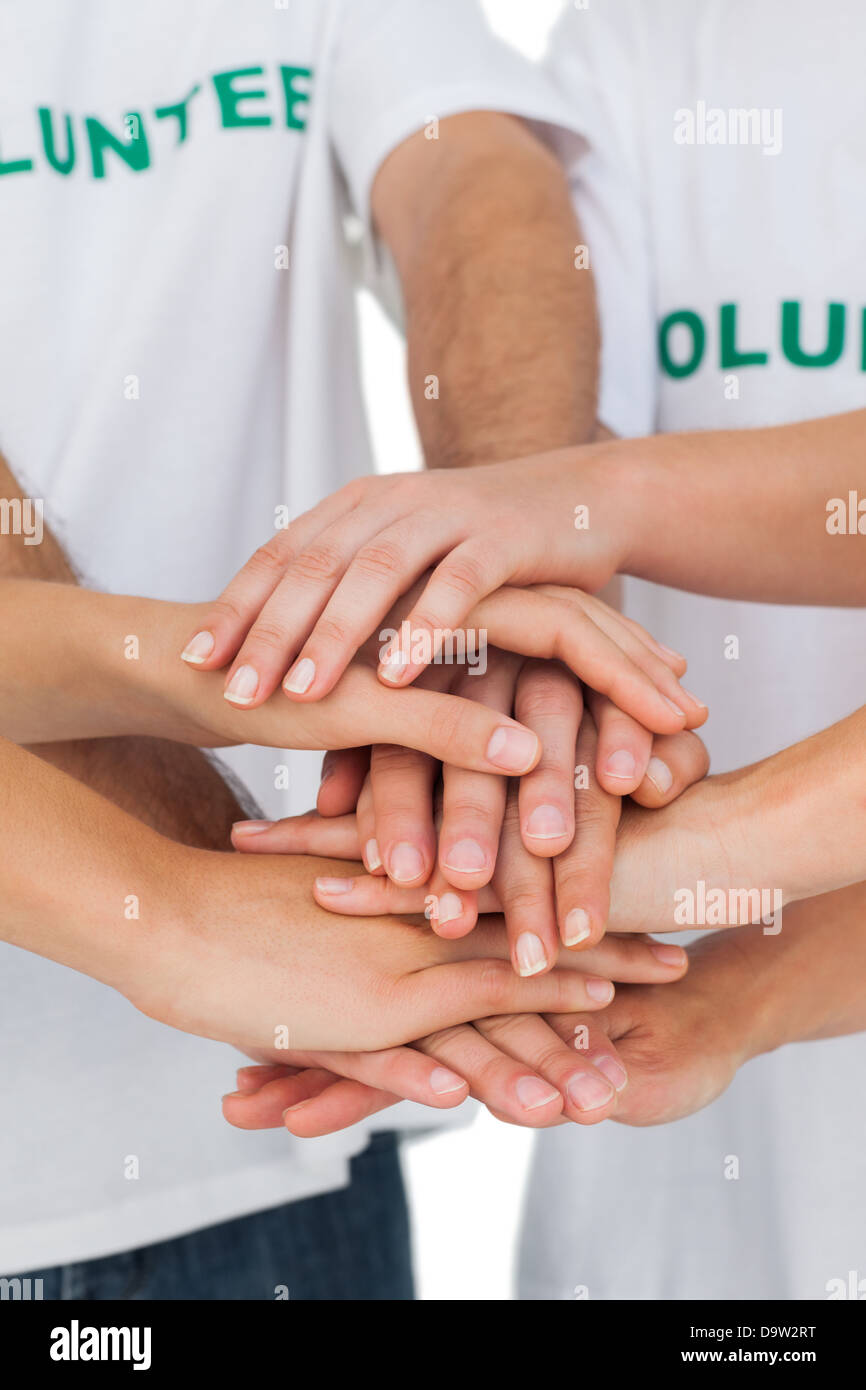 Volunteers putting hands together Stock Photo