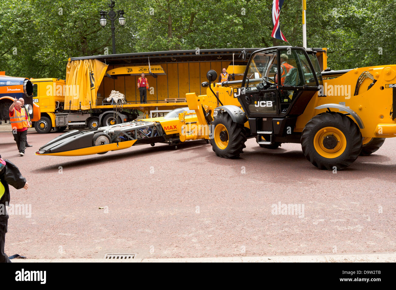 Loading the JCB dieselmax by forklift onto a lorry. Stock Photo