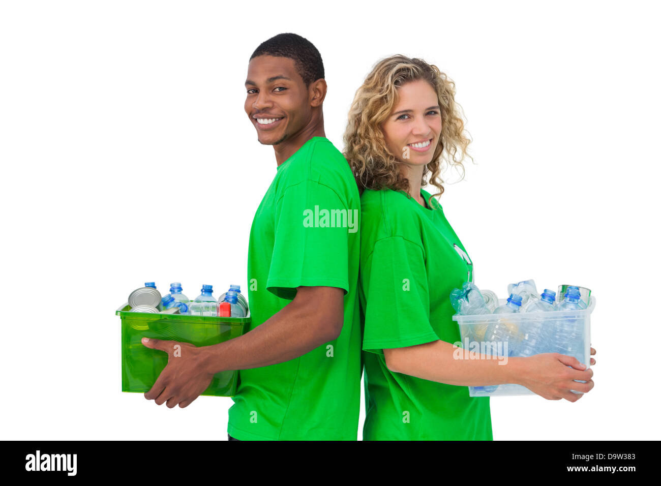 Cheerful environmental activists holding box of recyclables and standing back to back Stock Photo