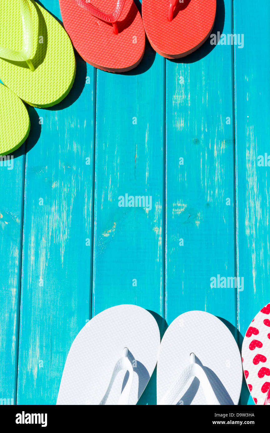 Colorful flip flops by a swimming pool Stock Photo - Alamy